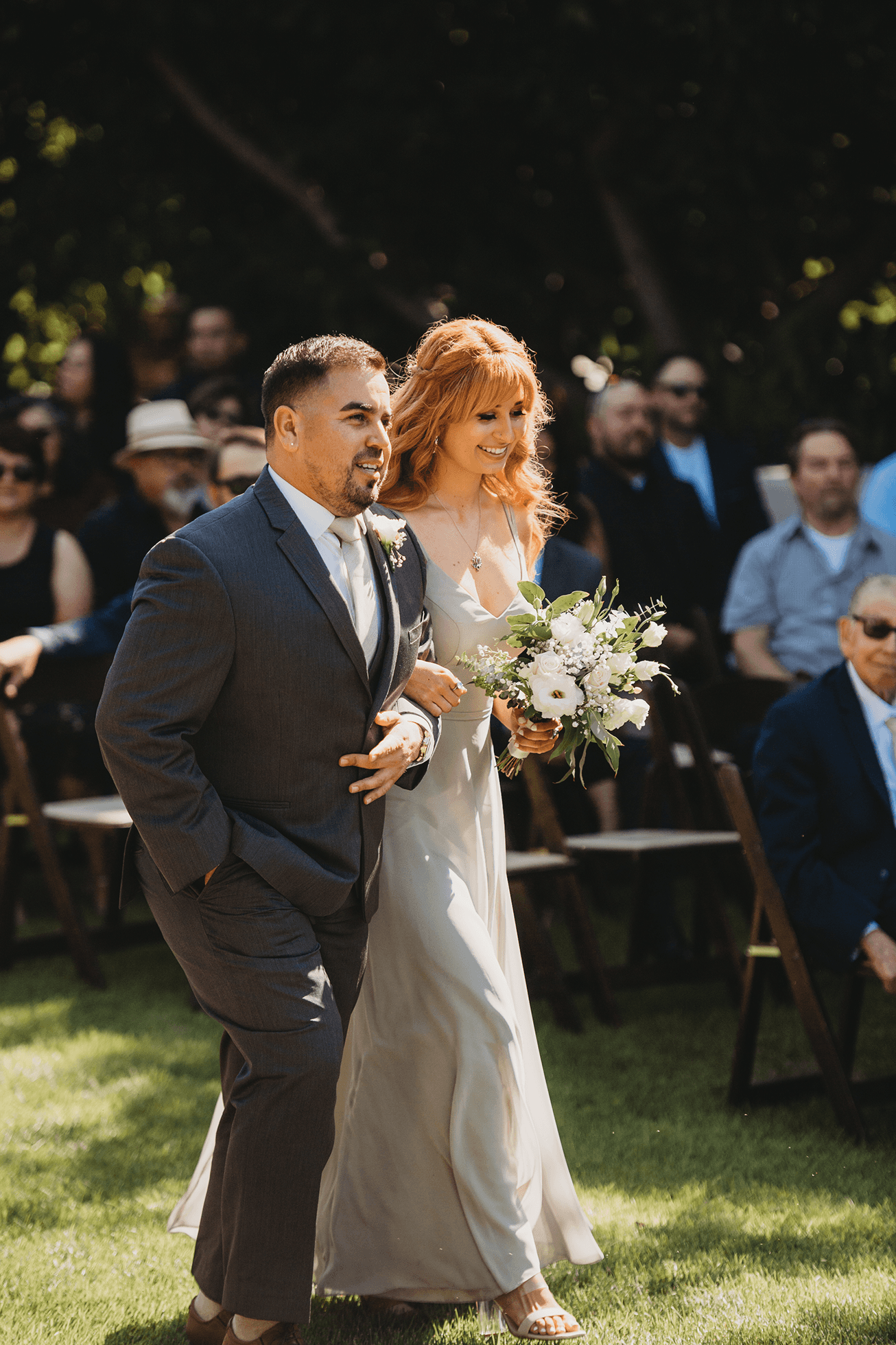Flat lay wedding details with bouquet, rings, and sparkling bridal heels