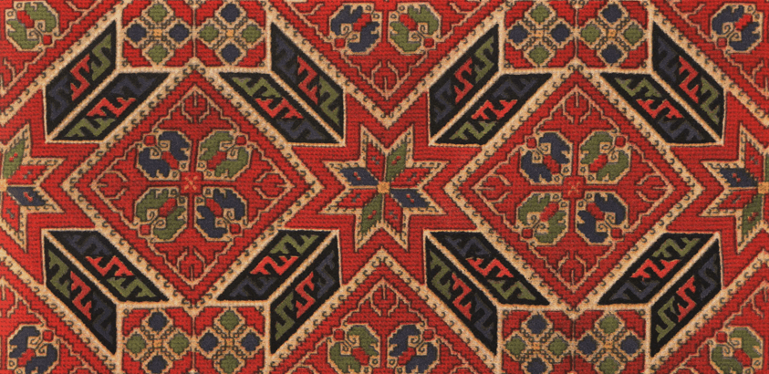 The new Bulgarian Culture Institute Bratislava logo placed on top of traditional embroidery