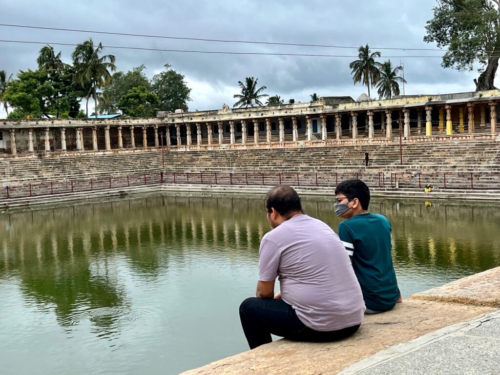 The huge Kalyani of Yoga Narasimha temple. People sit on the steps to enjoy the serenity of the place.