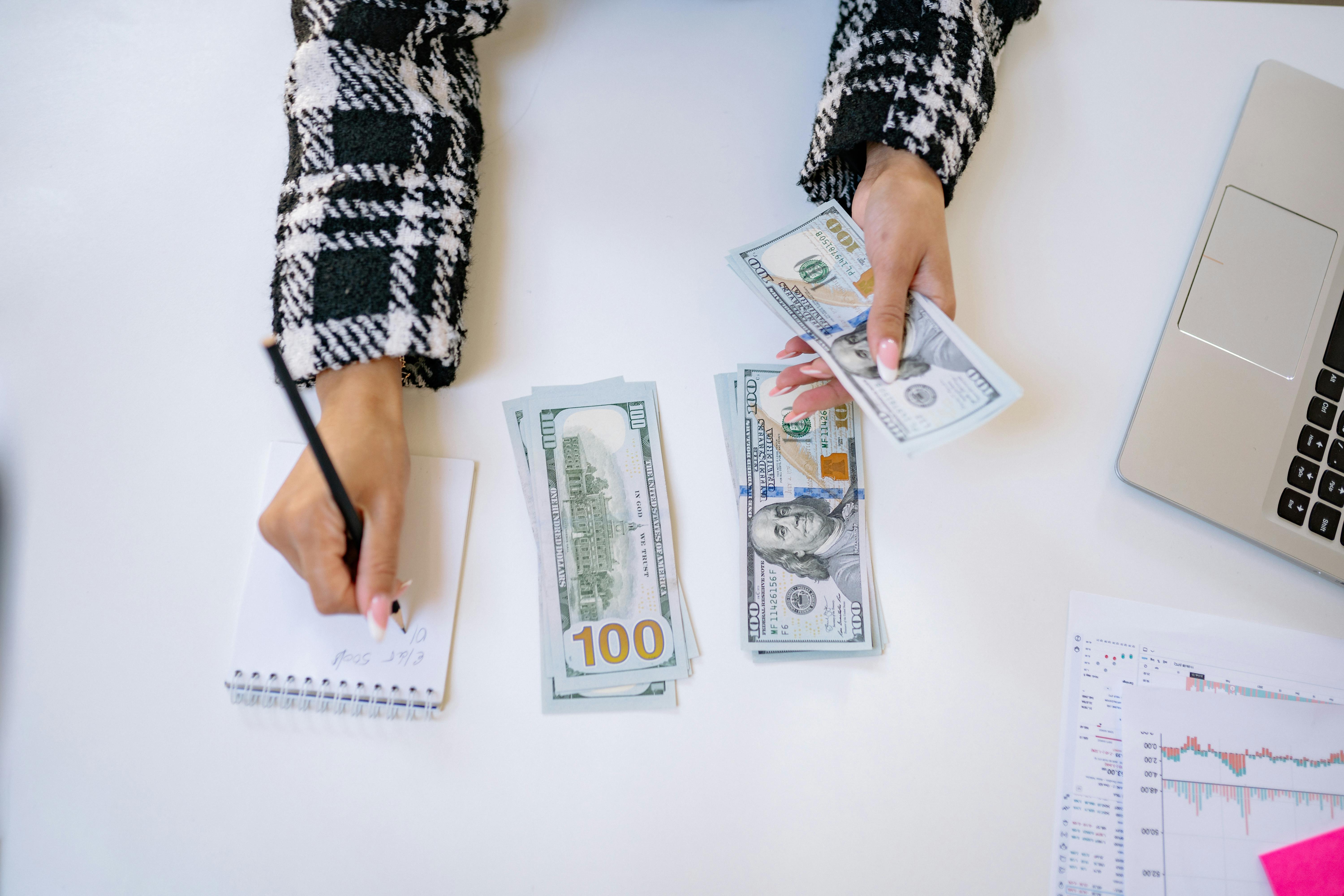 Woman counting money to pay broker fees