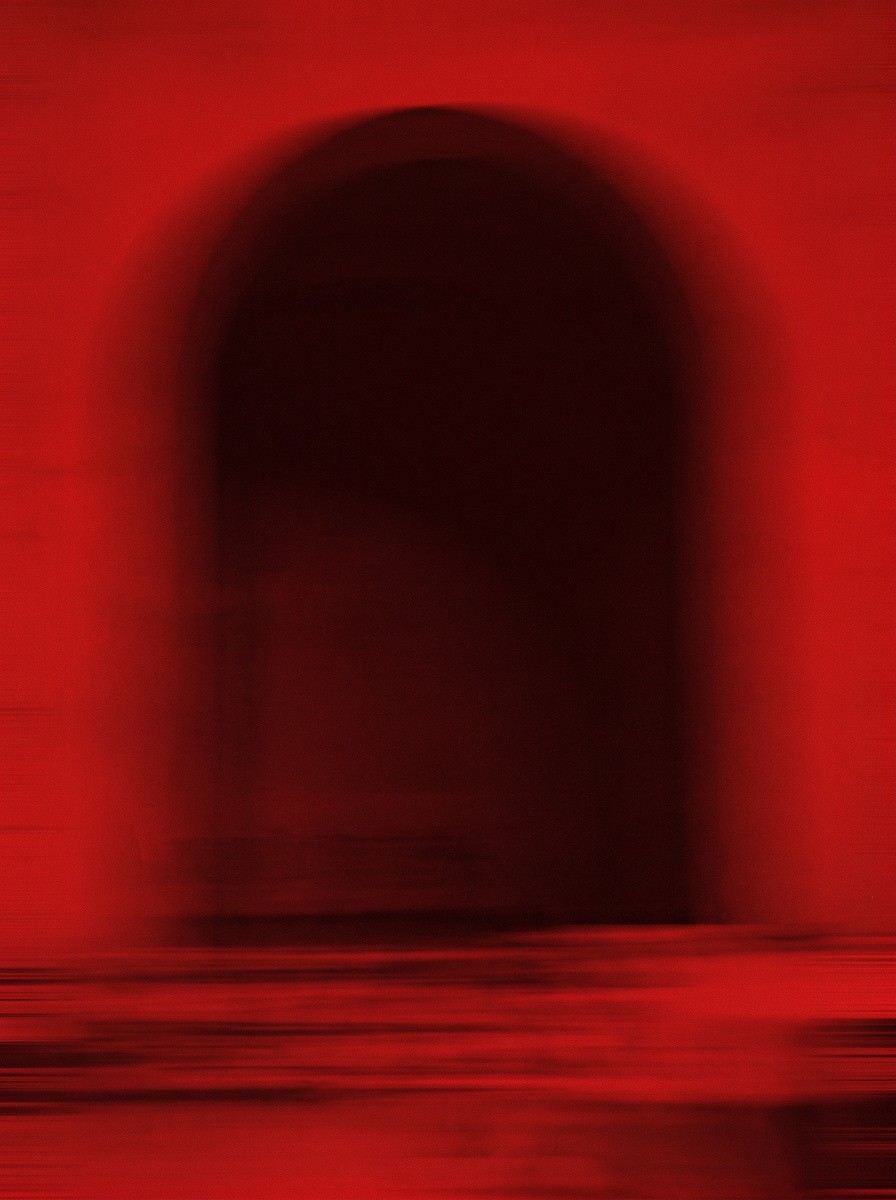Blurred silhouette in red light