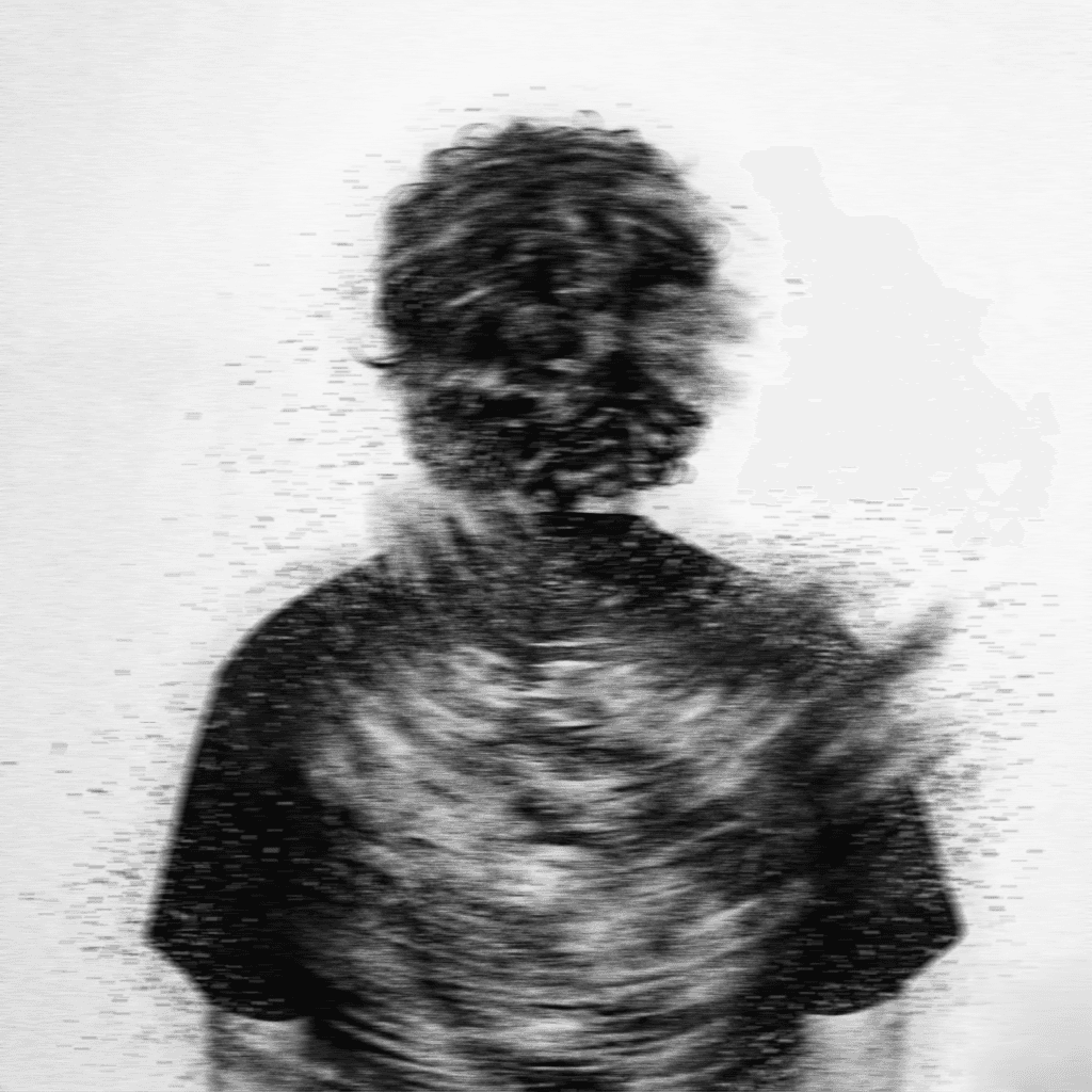 a blurry photo of a person standing in front of a wall