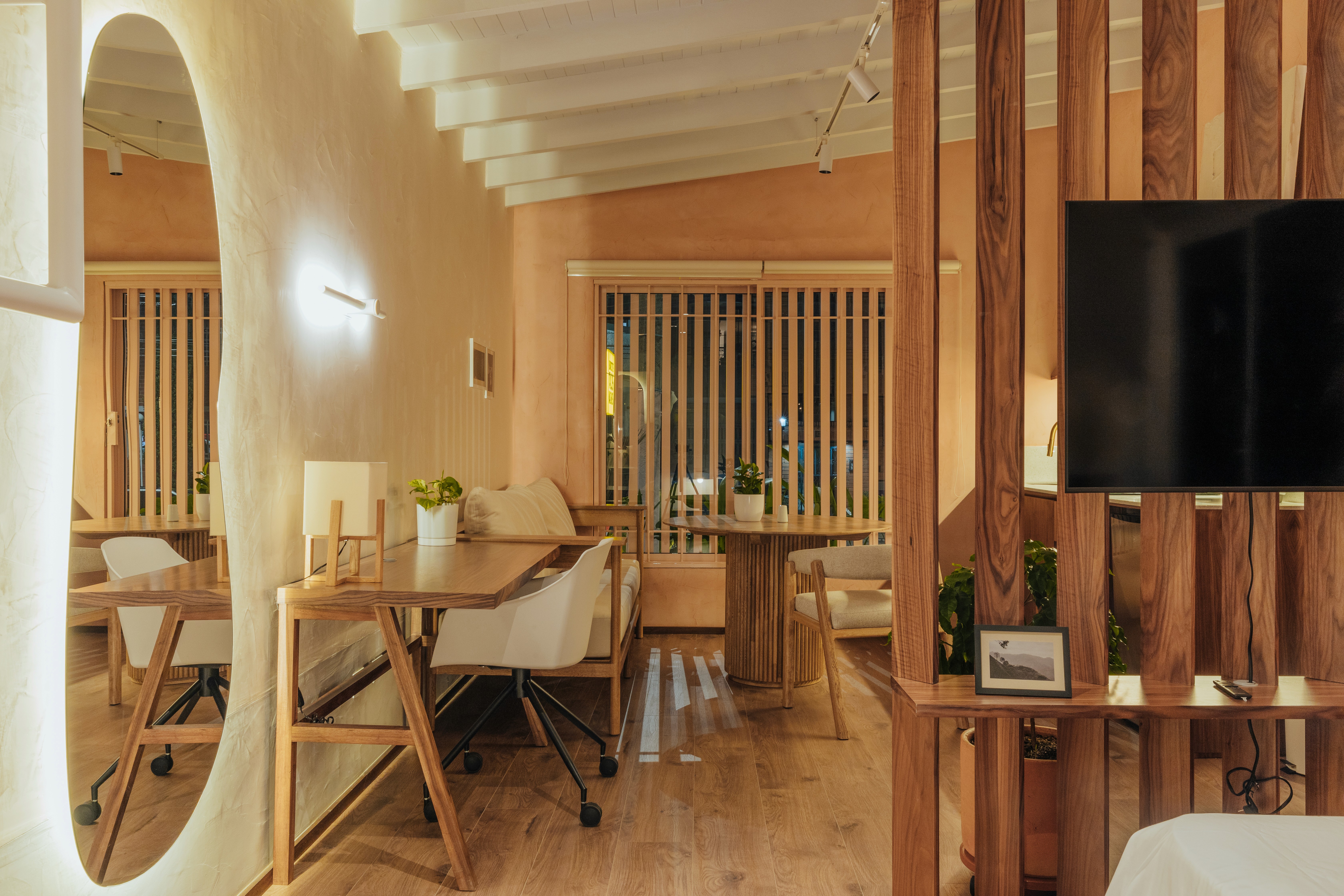 Double-height interior with flowing sculptural forms and warm raking light