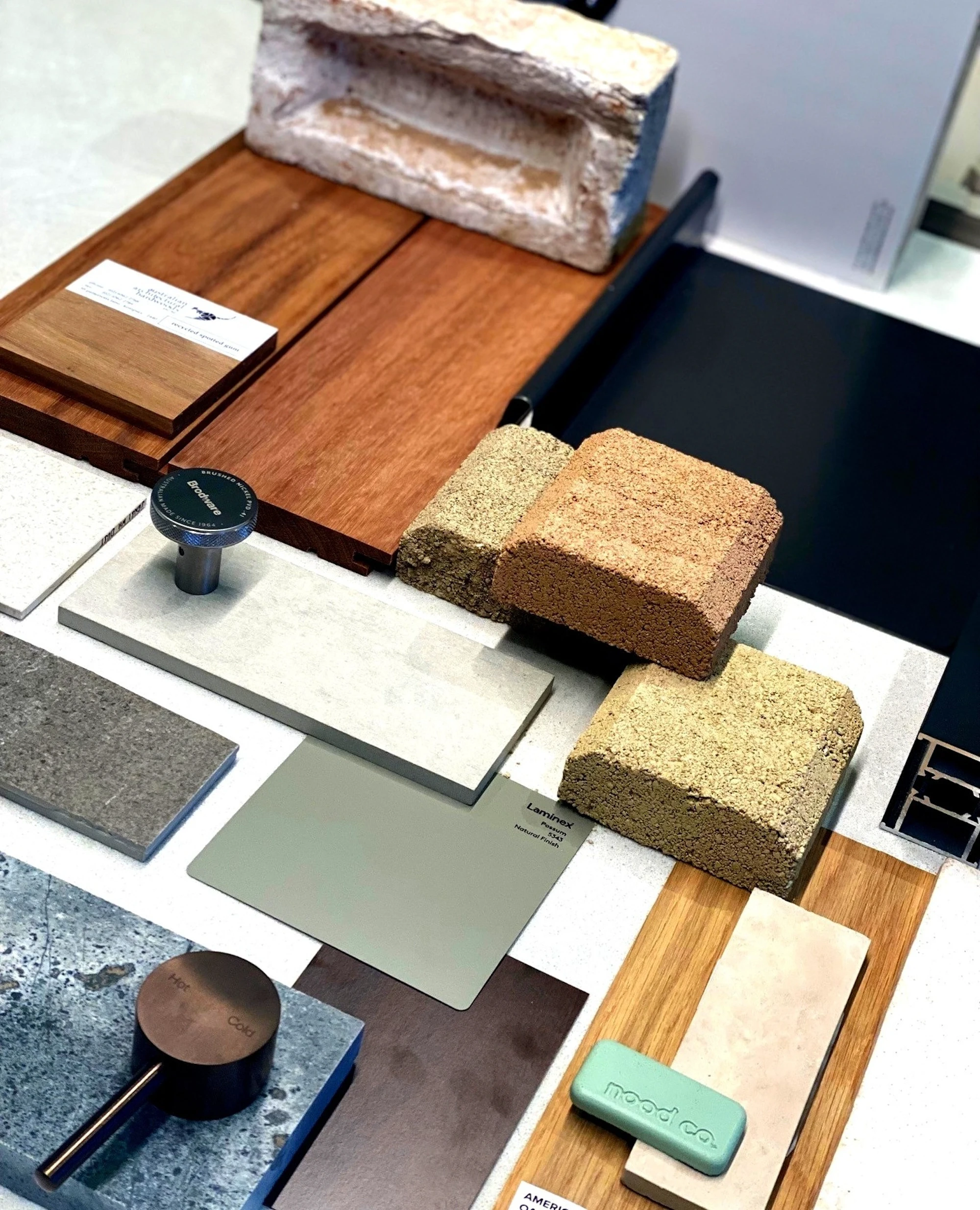 Architectural material palette featuring wood, stone, and texture samples.