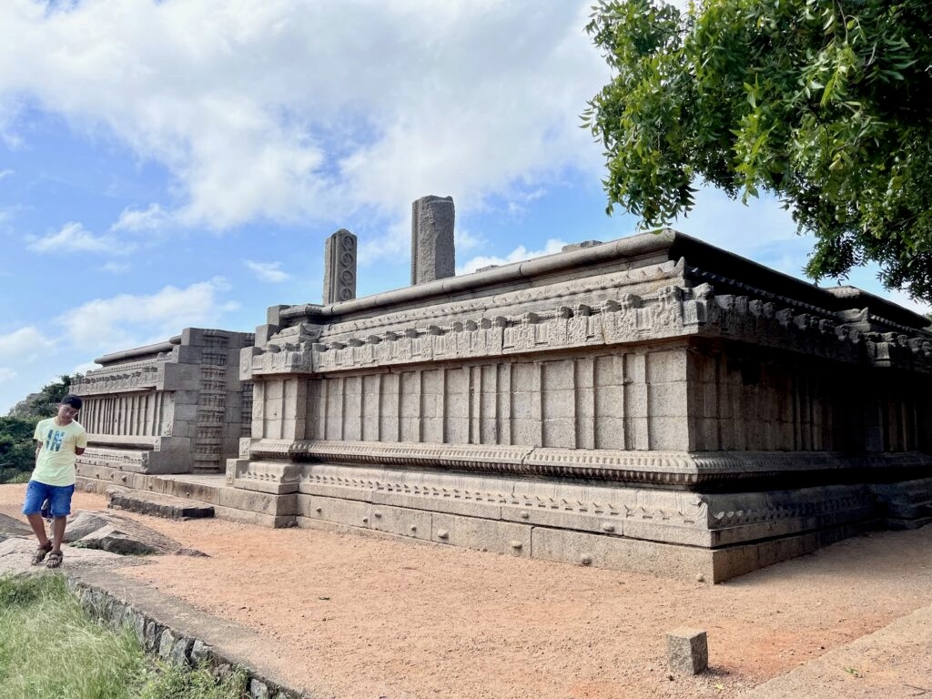 A stone base at Mahabalipuram with pillars.