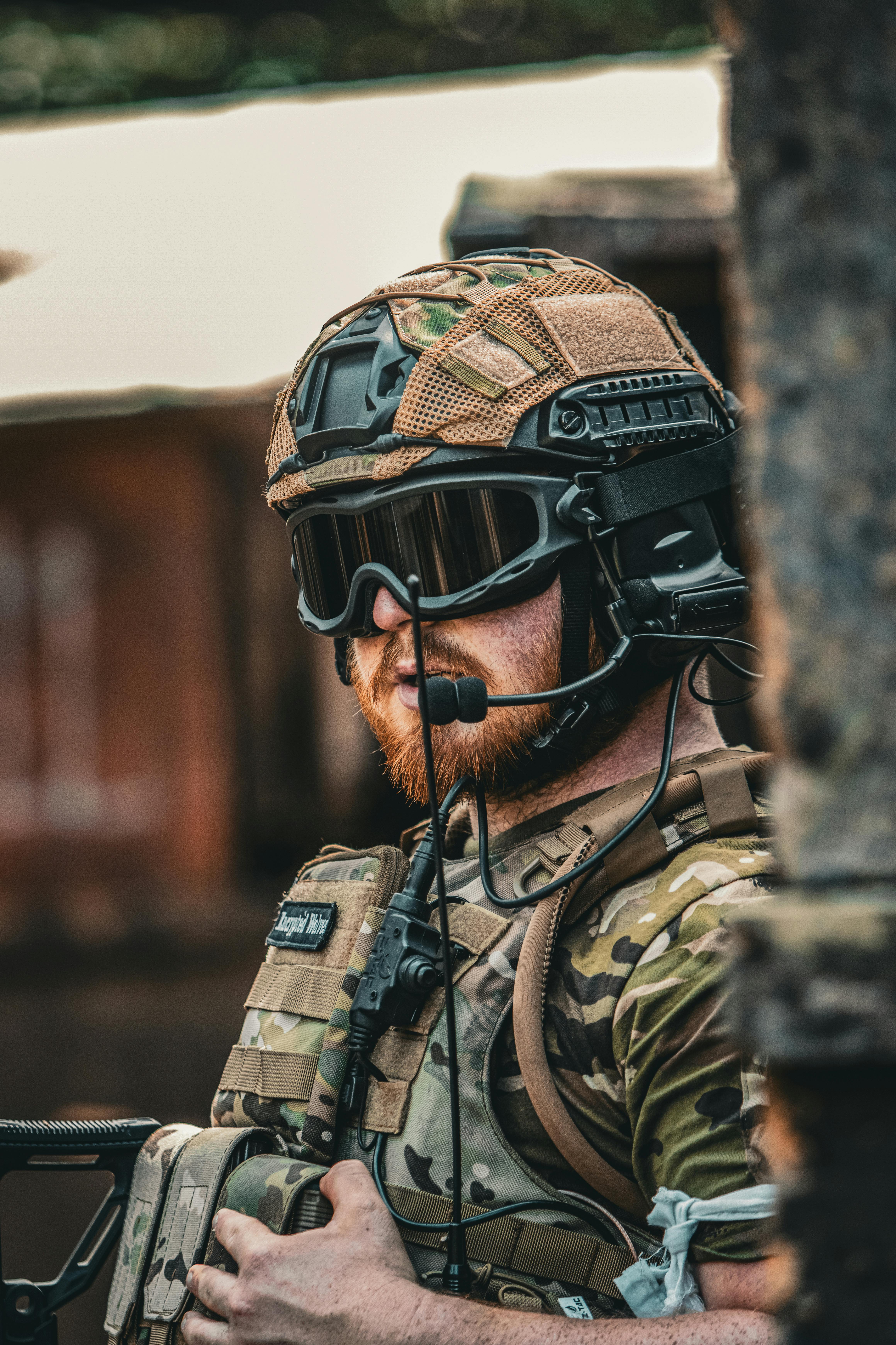 Combat engineer handling explosives or constructing field fortifications in combat gear.