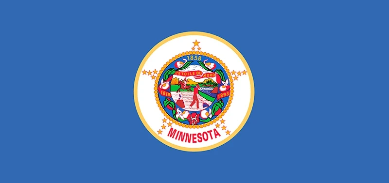 The Minnesota state flag features a blue backdrop with a circular emblem in the center, displaying a seal with a farmer and Native American, surrounded by stars and floral elements.