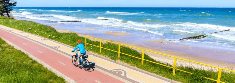 brown concrete building near body of water during daytime