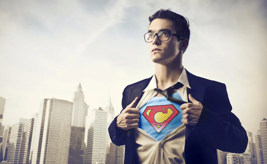 A man revealing a Superman emblem beneath his shirt