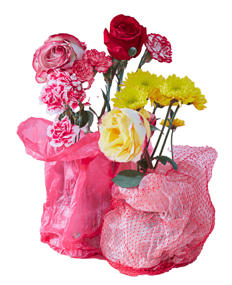 A vibrant bouquet of flowers wrapped in pink and netted coverings, featuring red and yellow roses, pink carnations, and yellow chrysanthemums.