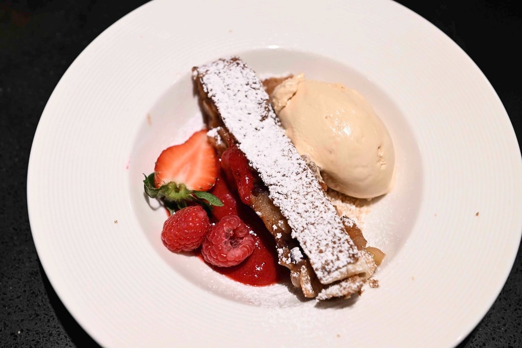 a vanilla ice cream with matcha cream served in a white plate
