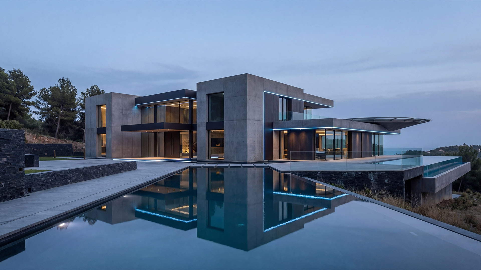 High-end contemporary villa in Marbella with infinity pool, reflective water surface, and modern concrete architecture at dusk