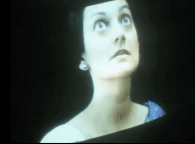 A man playing a drum in front of a group of people