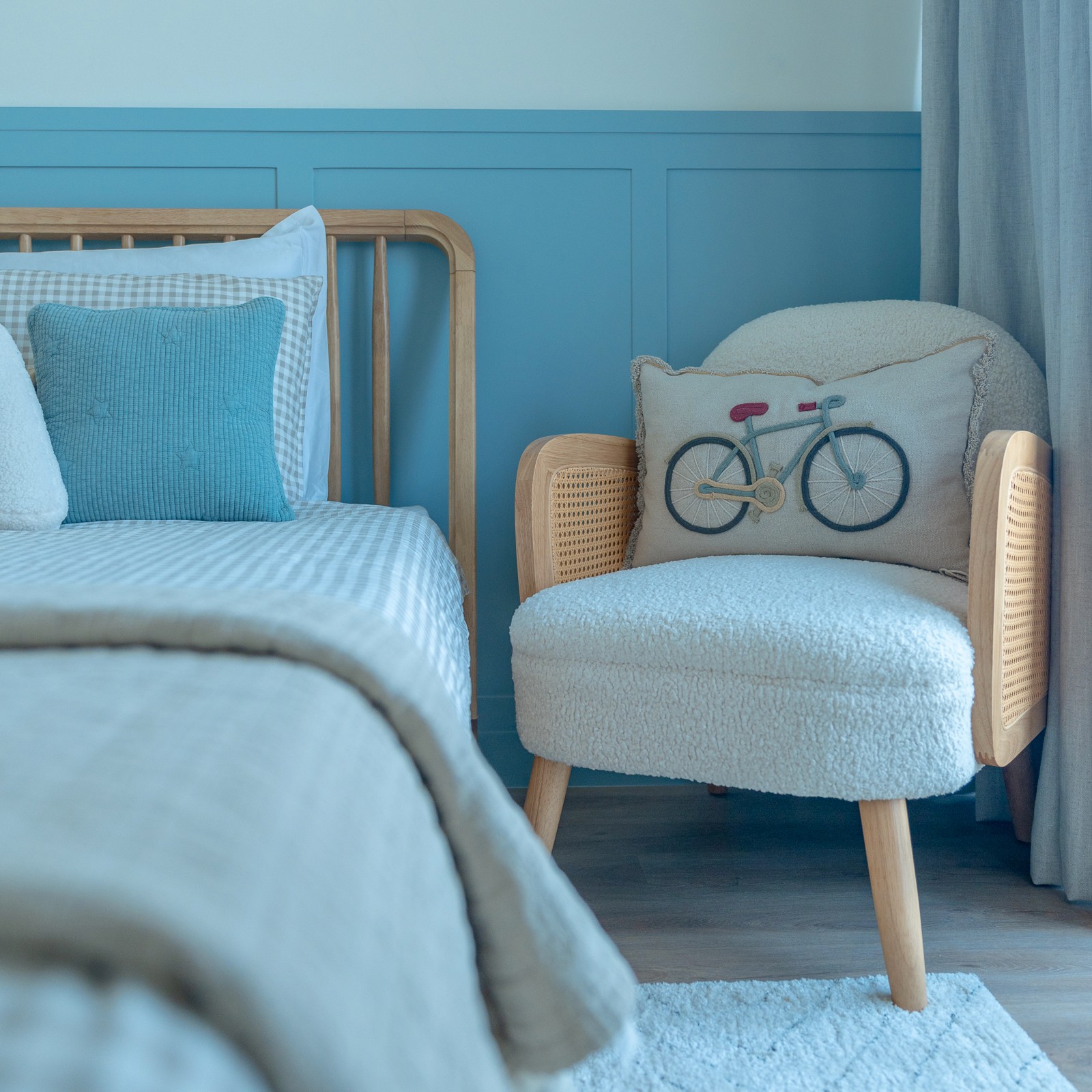 A chair and a bed in a bright, colorful child's bedroom