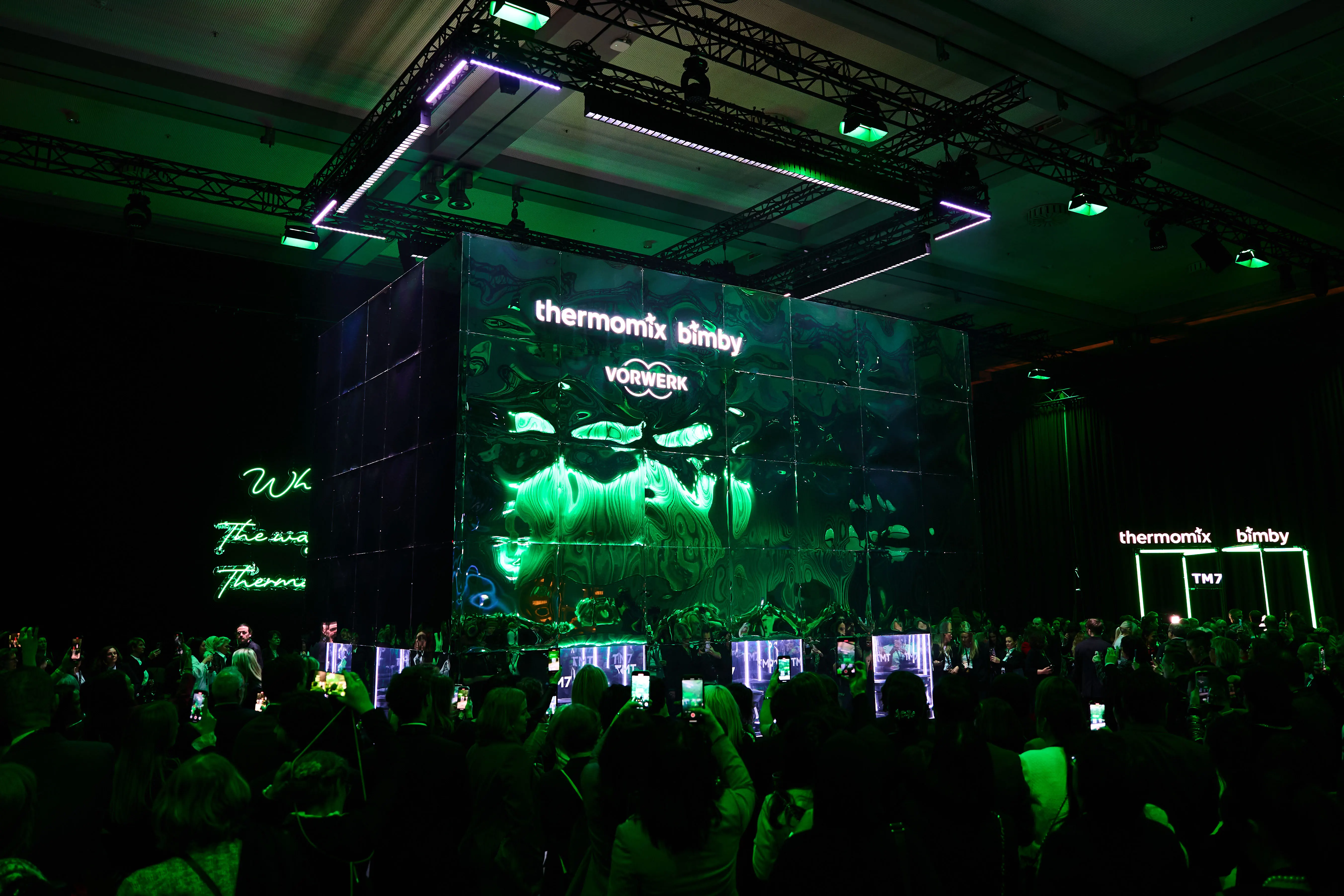 Crowd in front of the green-lit Thermomix Bimby LED cube at the product reveal.