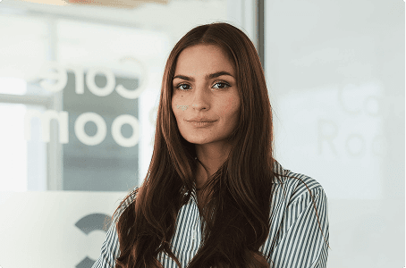 A smart dressed woman standing in an office