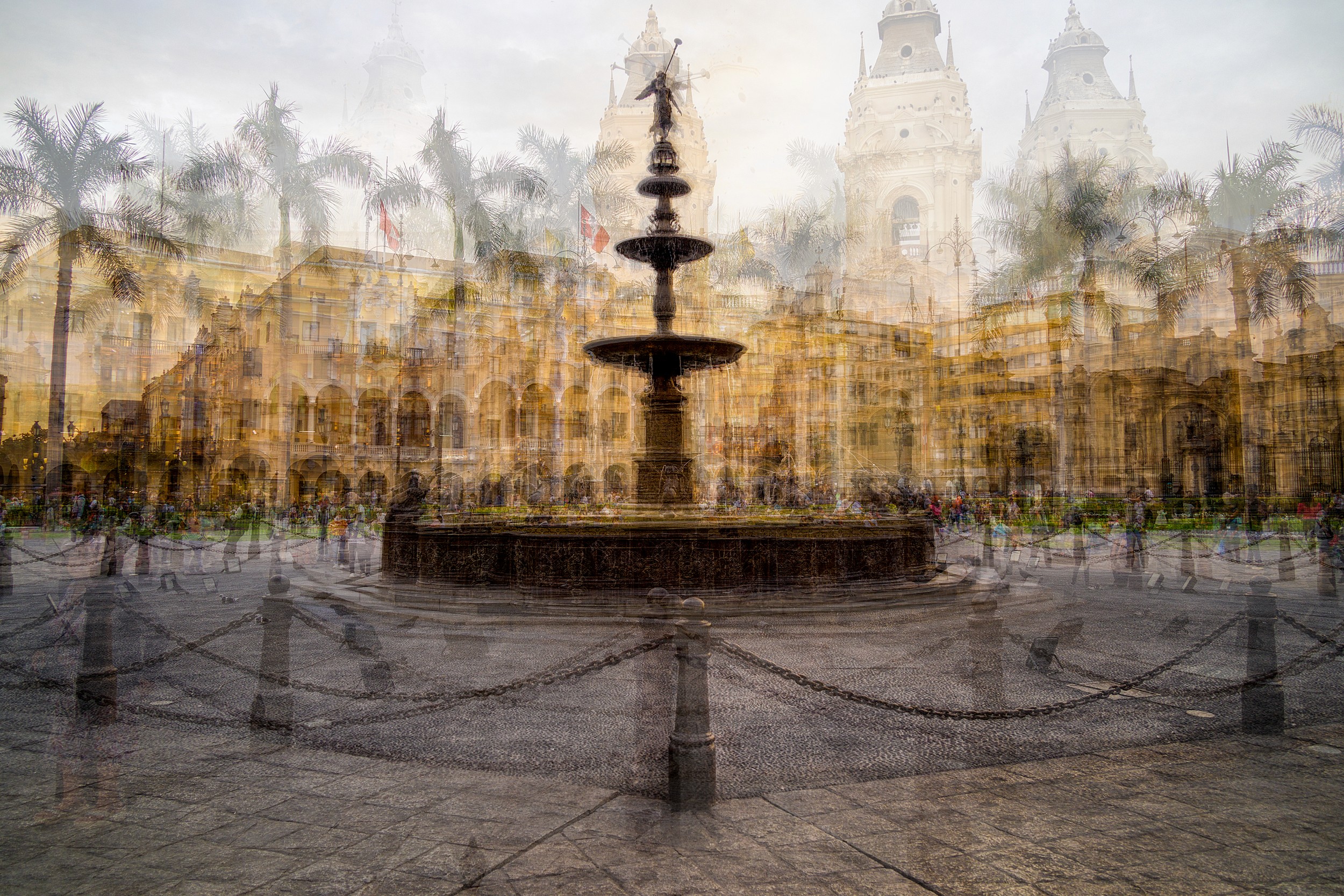 Multiple exposures of a colonial plaza with a fountain and cathedral towers layered in golden light
