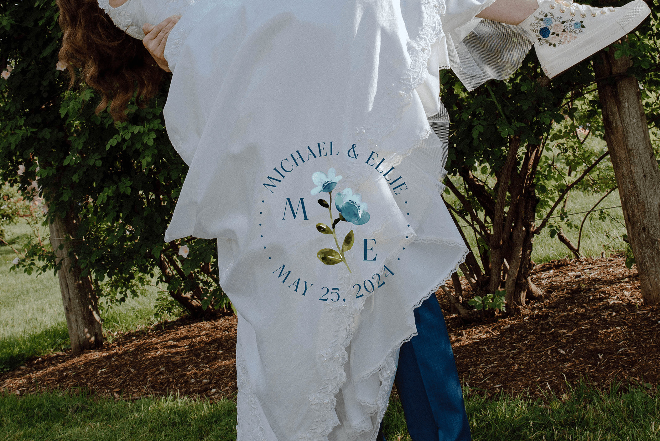 Graphic design mockup of a logo for a wedding over a bride in her white dress and groom — illustrated, brandmark logo with a clean brandmark with an elegant serif typography, designed by Will Lefkovich.