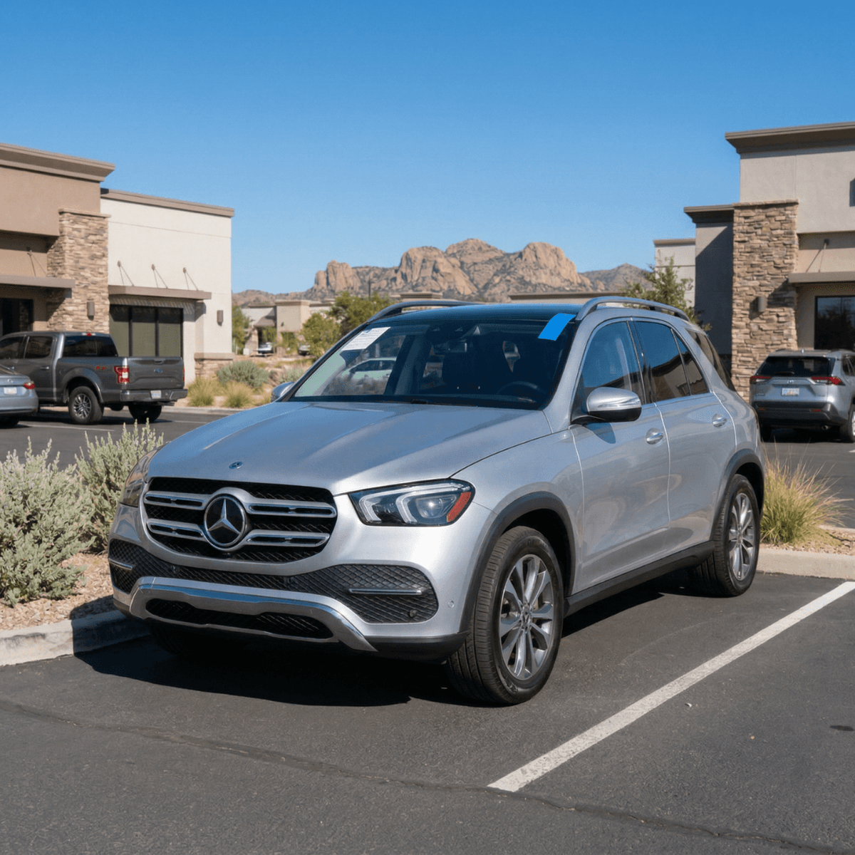 Mobile windshield repair on a silver Mercedes-Benz GLE at a South Tucson business park