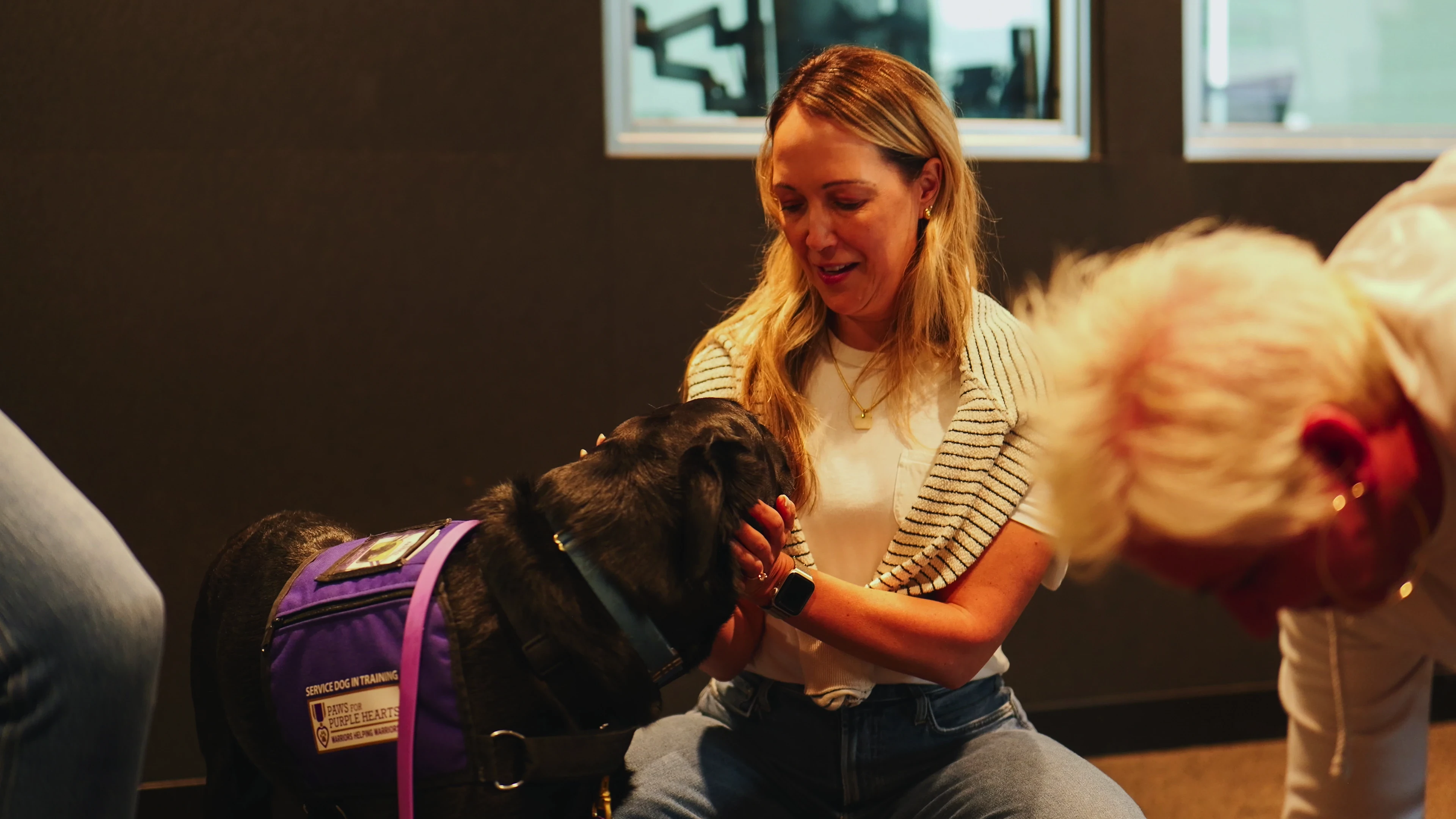 Eagle Paving rep giving some love to a Paws for Purple Hearts service dog