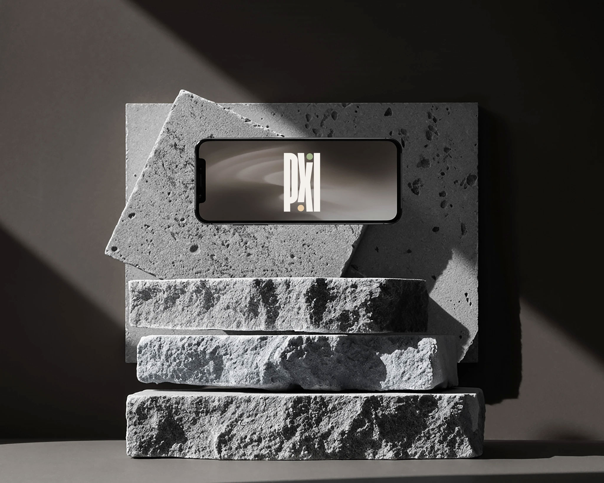A smartphone displaying the Pixil brand interface, placed on a dark textured stone surface against a moody background.