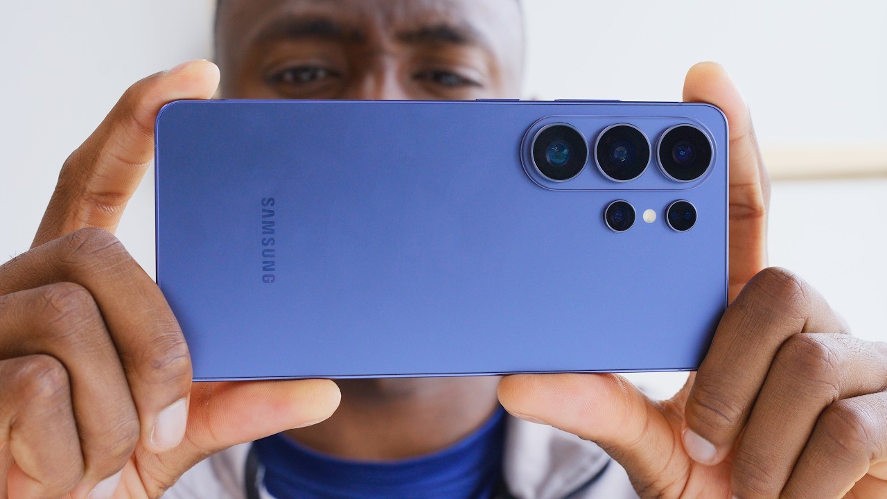 MKBHD-style smartphone review thumbnail with blue flagship phone and blurred creator background