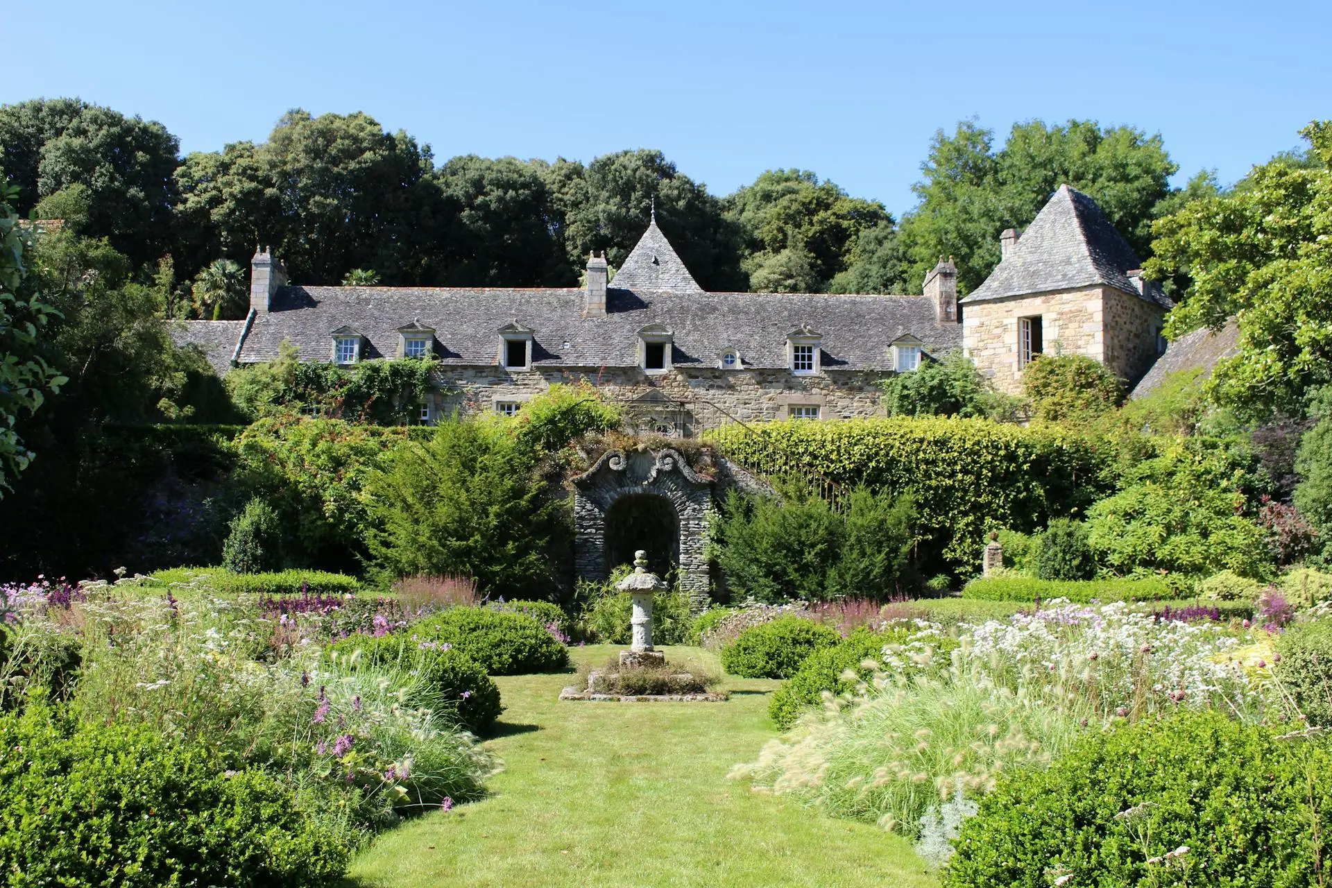 Historic French château estate surrounded by gardens, representing ecological heritage restoration and conscious slow living in rural France
