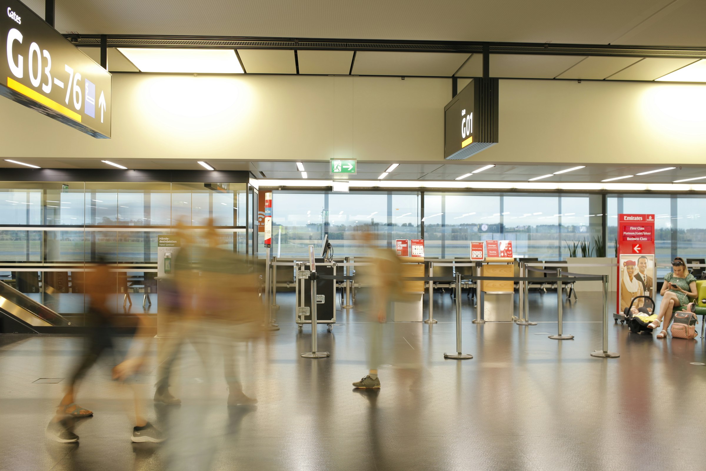 Bright airport gate area with travelers walking