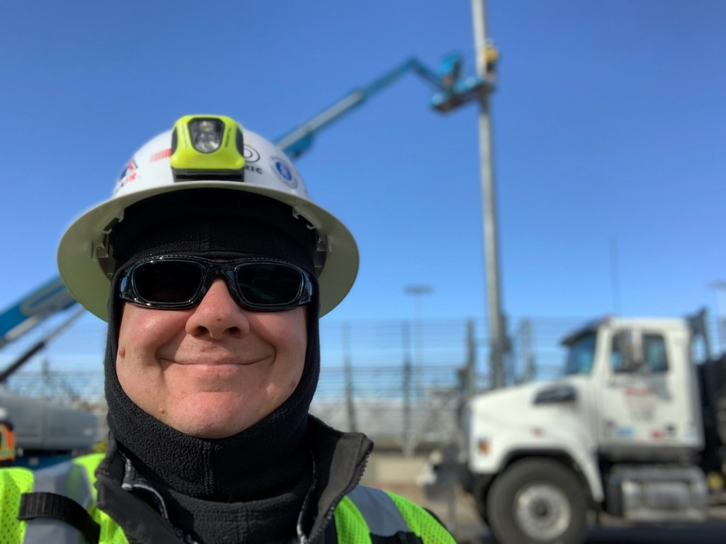 man in green and black jacket wearing white helmet