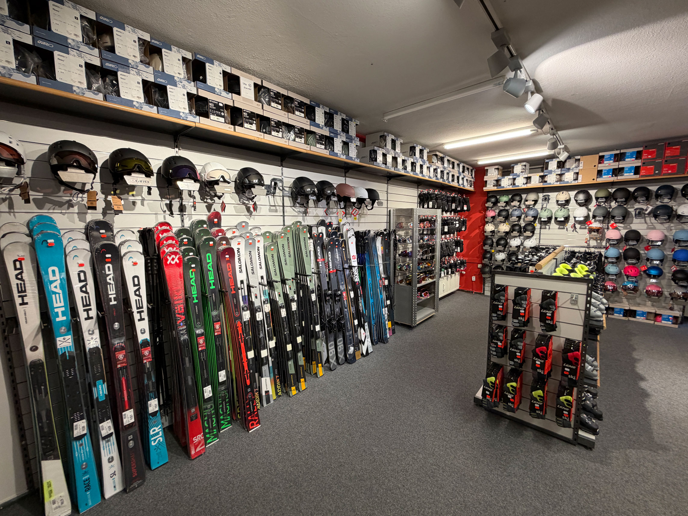 group of people in red jacket and pants standing on snow covered ground during daytime