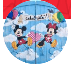 The image shows a colorful mural with two cartoon characters, balloons, and "celebrate!" on a light blue background.