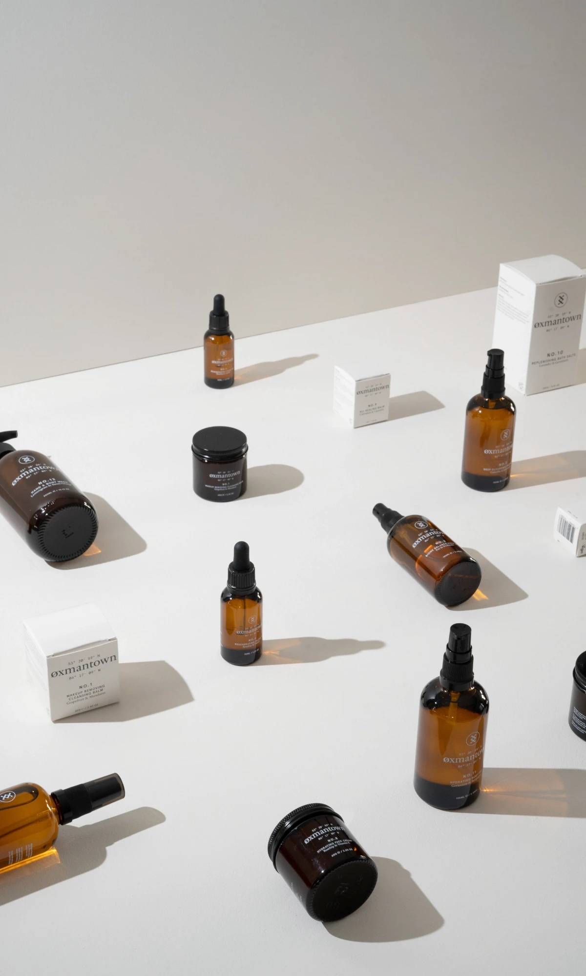 a grid of products, various bottle and jar sizes, placed on a isometric grid, with some lying down on their side