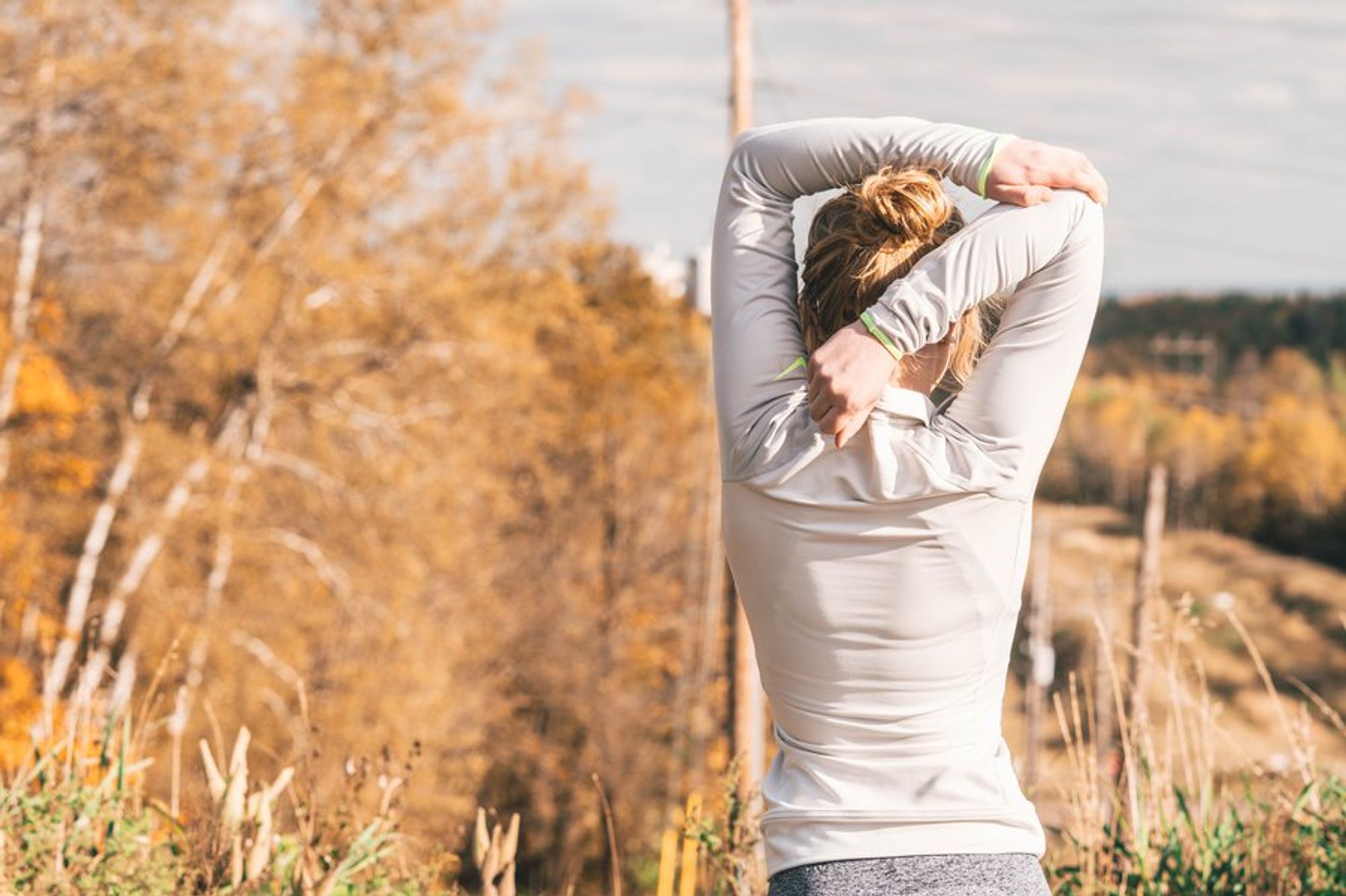 A woman stretching under the sun