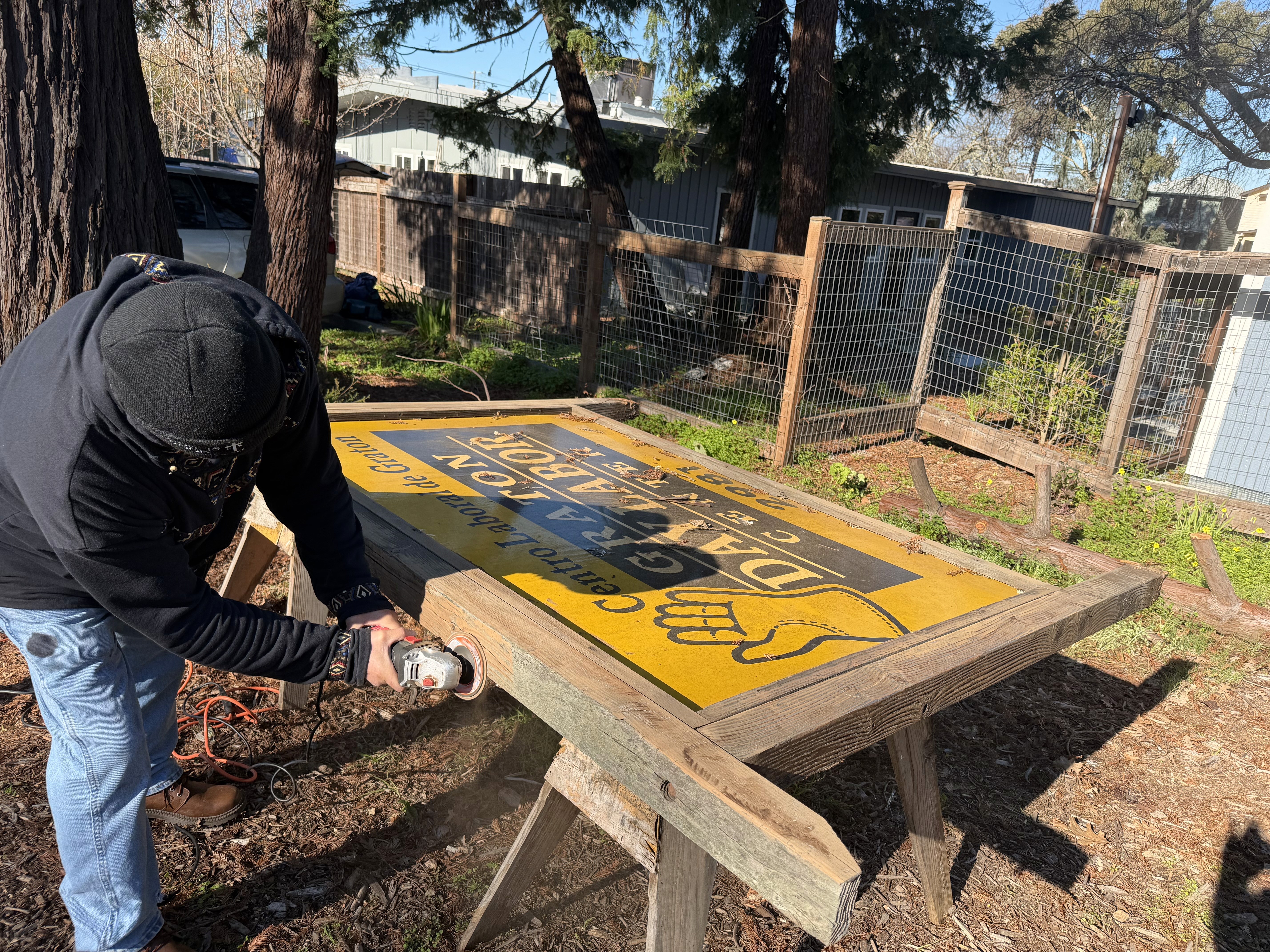 group of women in red and white dress standing on brown wooden bar during daytime