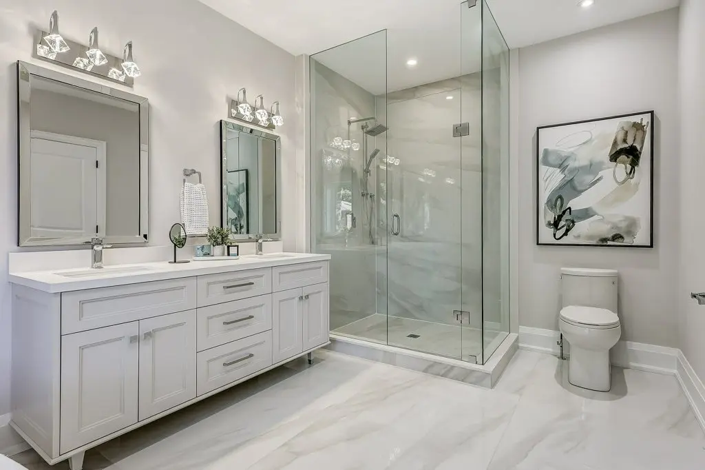 Photo of primary ensuite bath with double sink and large shower.