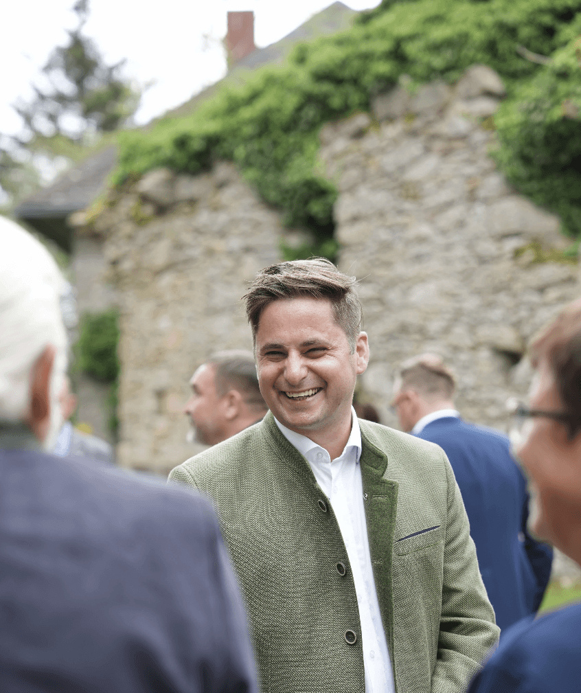 Couple sitting with hot air balloons at sunset