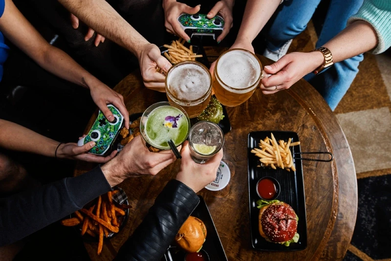 Group of people sitting in a VIP booth enjoying food and drink