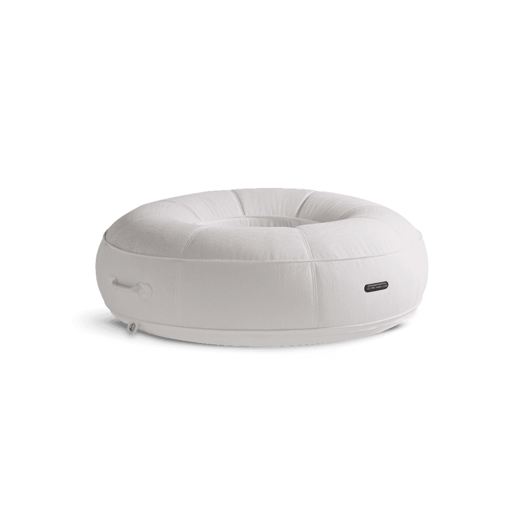 All-white luxury pool float in plush chenille weave with quilted panels, white base, and white hardware