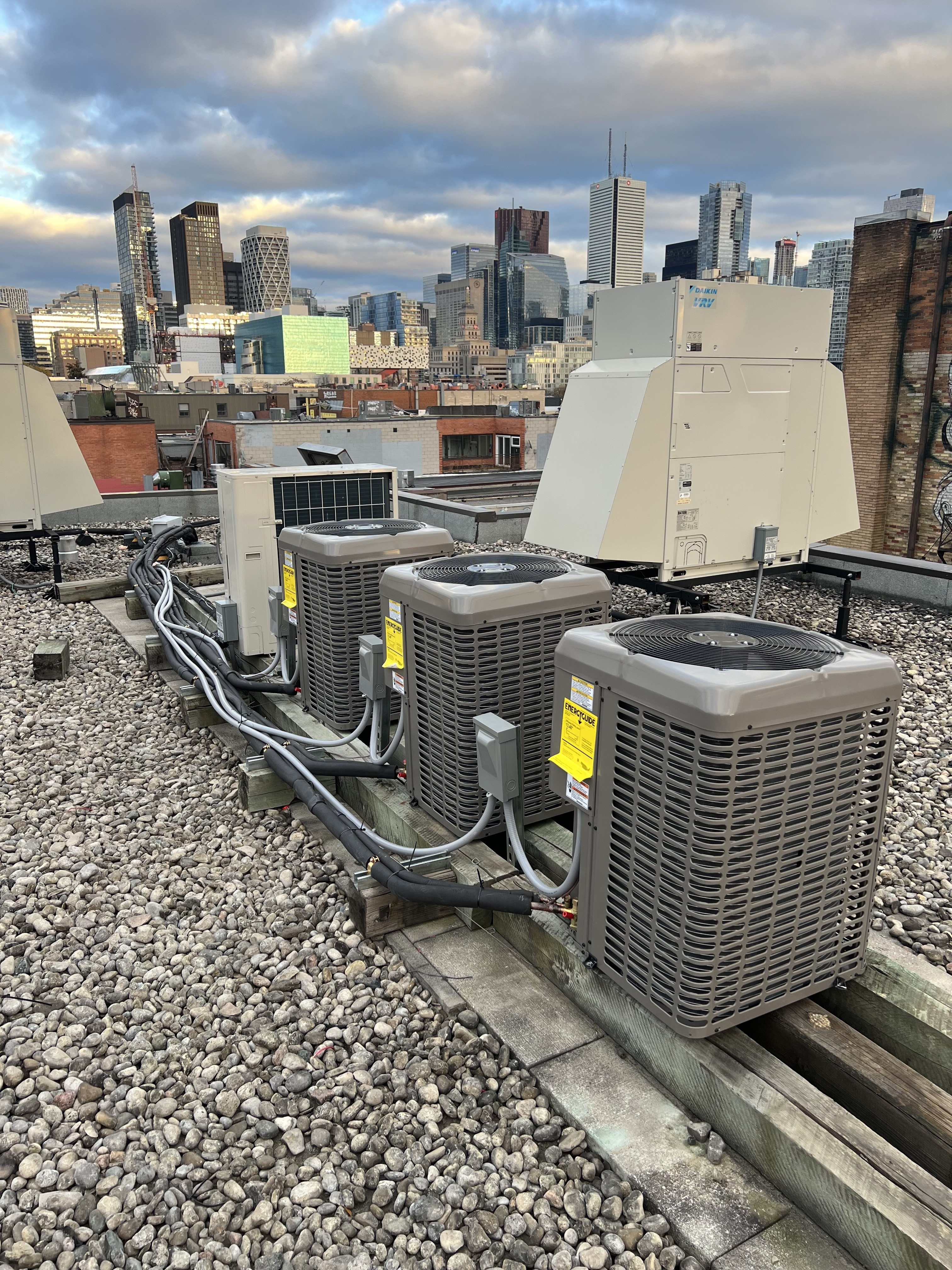Commercial rooftop HVAC units installed on a Toronto building