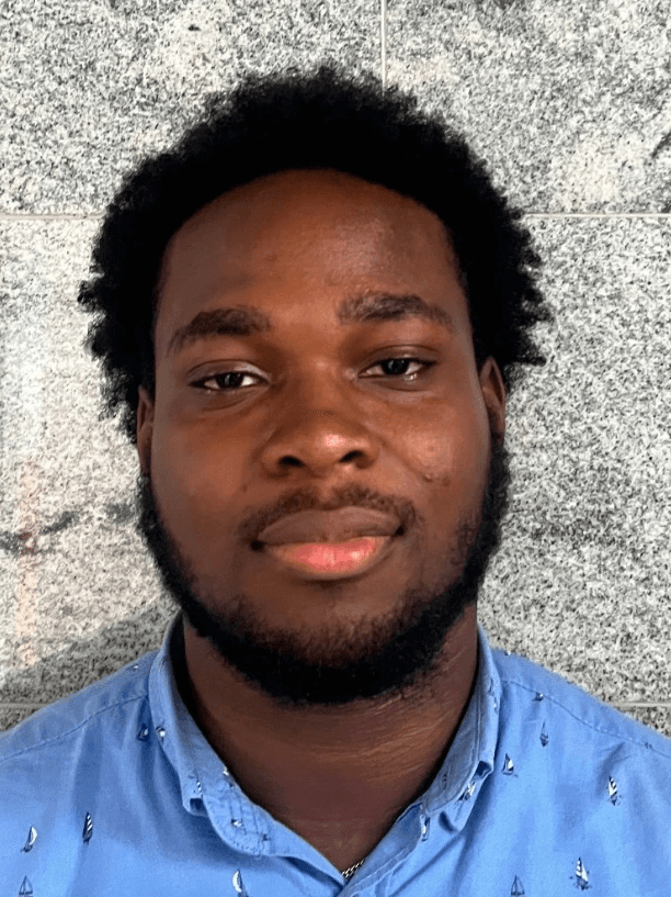 a man with a goatee smiles at the camera