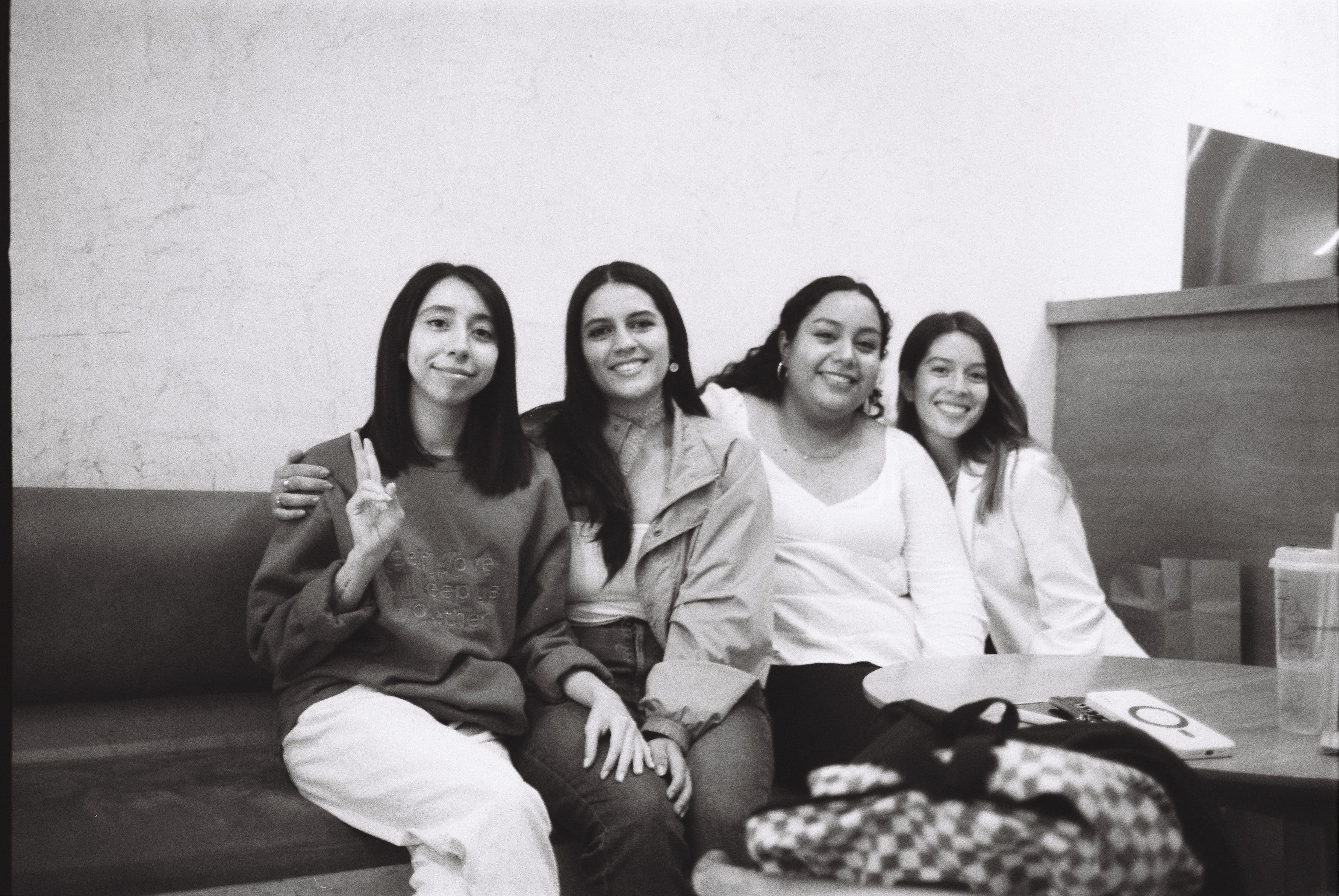 women posing seated side by side