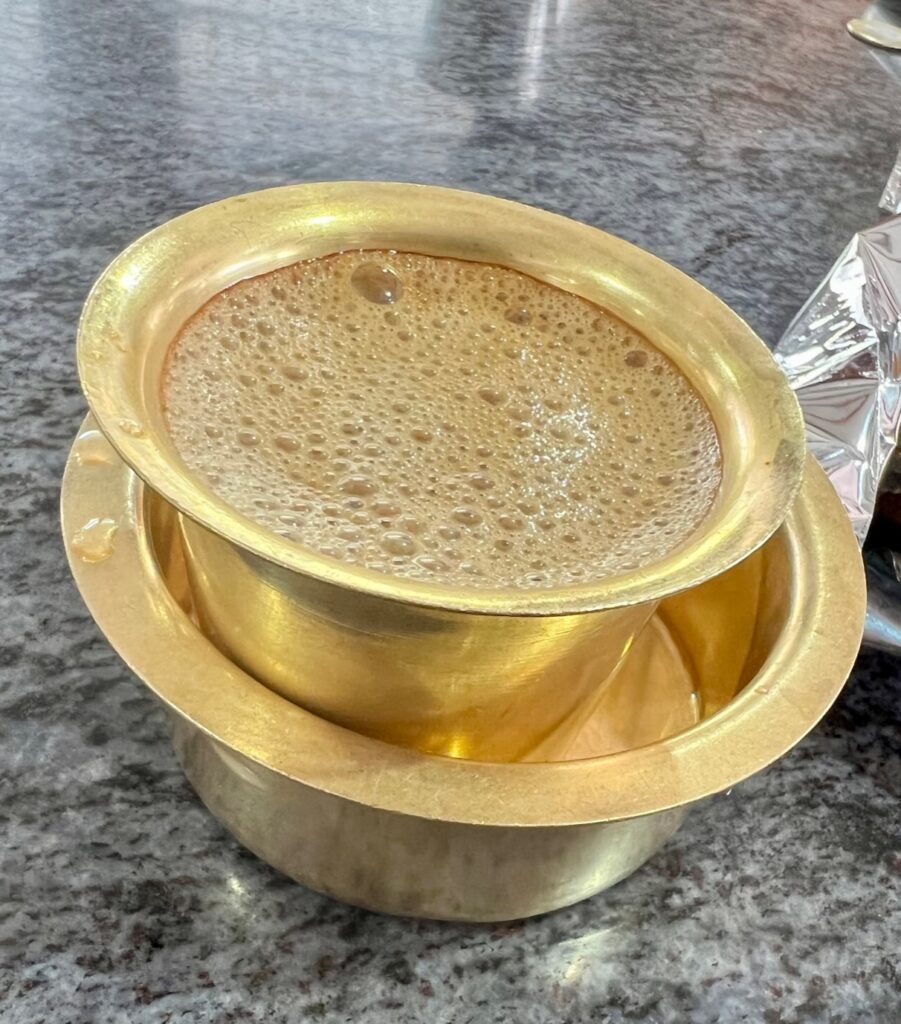 Kumbakonam degree coffee (filter coffee) served in a brass davara tumbler.