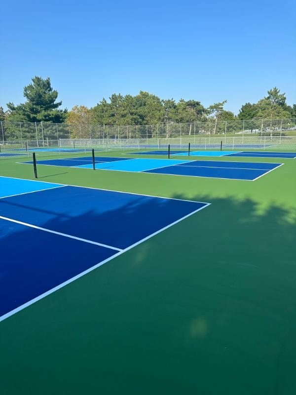Arcadia’s Memorial City Park resurfaced with acrylic coating, featuring crisp lines for both tennis and pickleball after surface repairs.