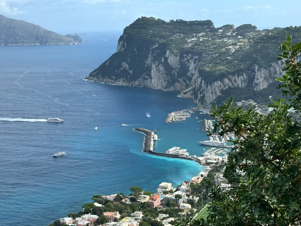 The harbour at Marina Grande with ferries and boats, below Capri's steep cliffs.