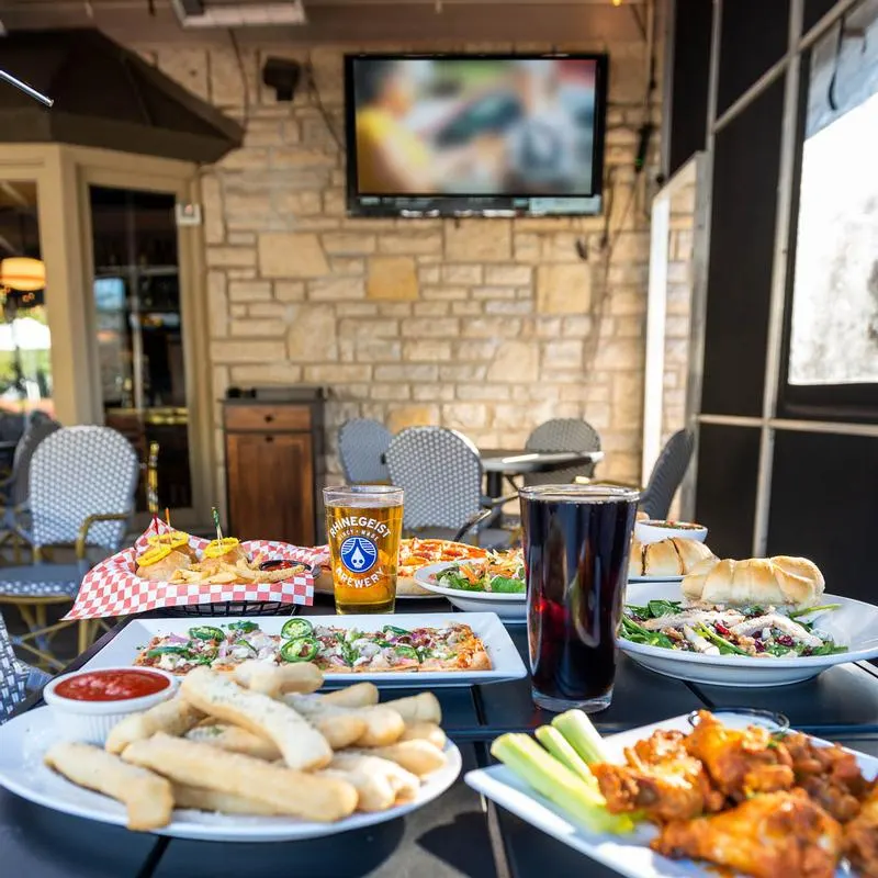 Salads, Italian fries, flatbread and drinks on a table