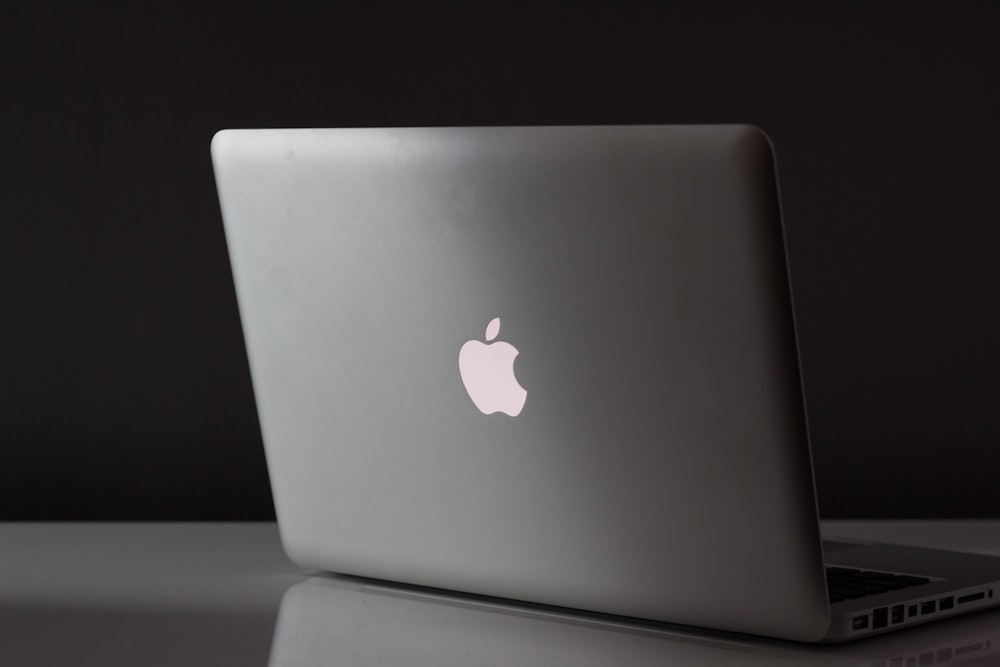 A MacBook on a desk with atmospheric lighting