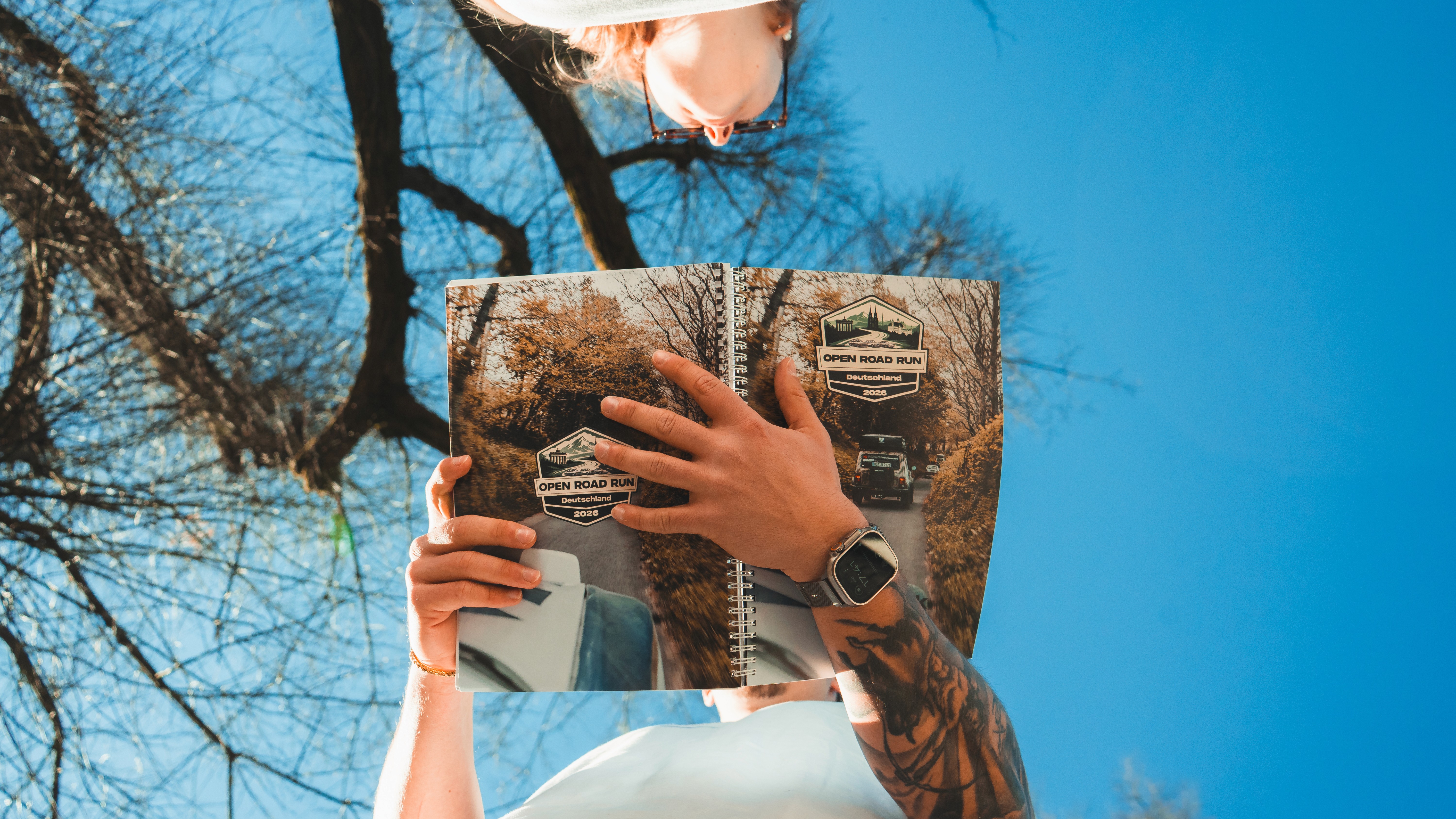 Camel caravan crossing vast golden dunes in AlUla, symbolizing traditional desert journeys.