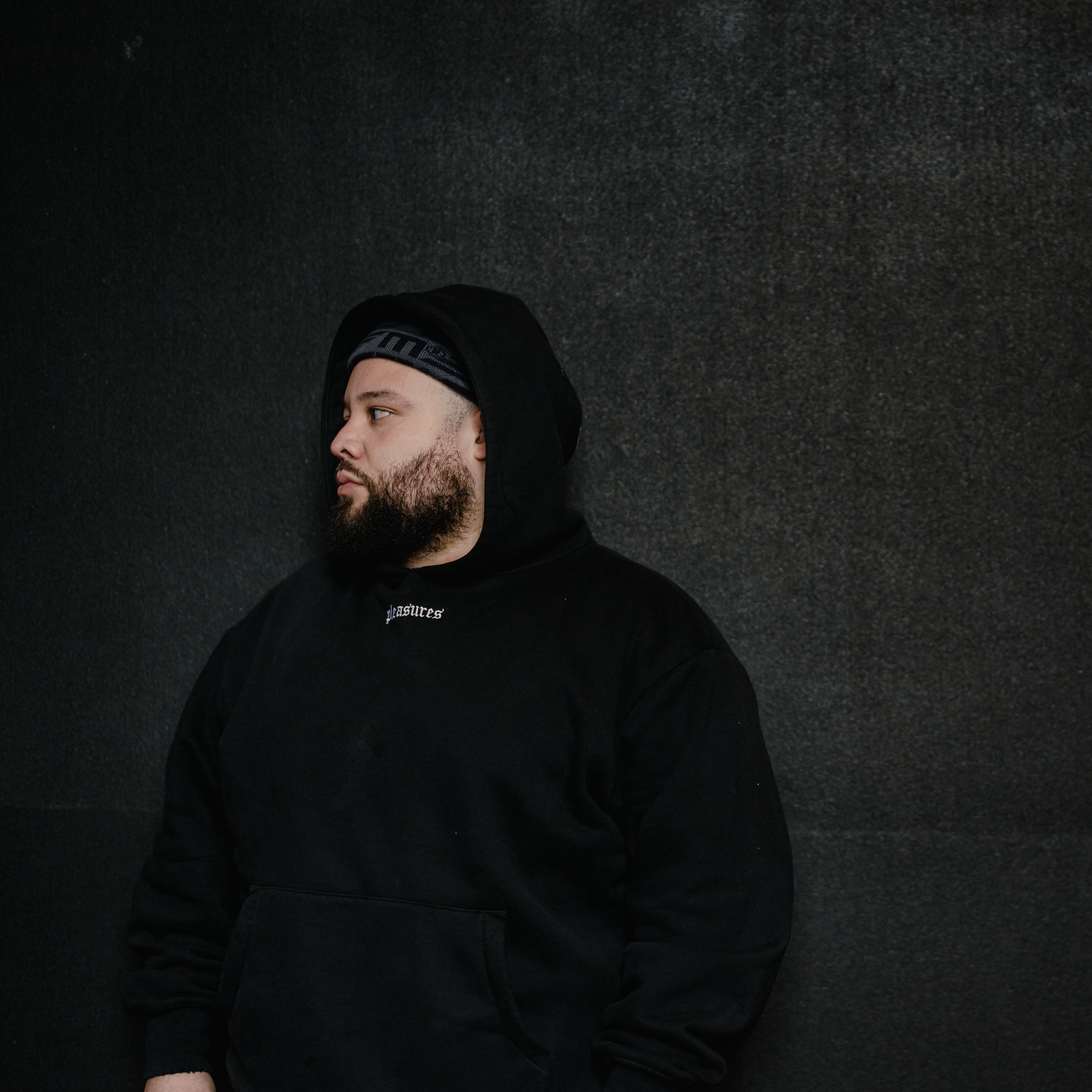 Person, holding a white rose behind his back with one arm on a light blue background