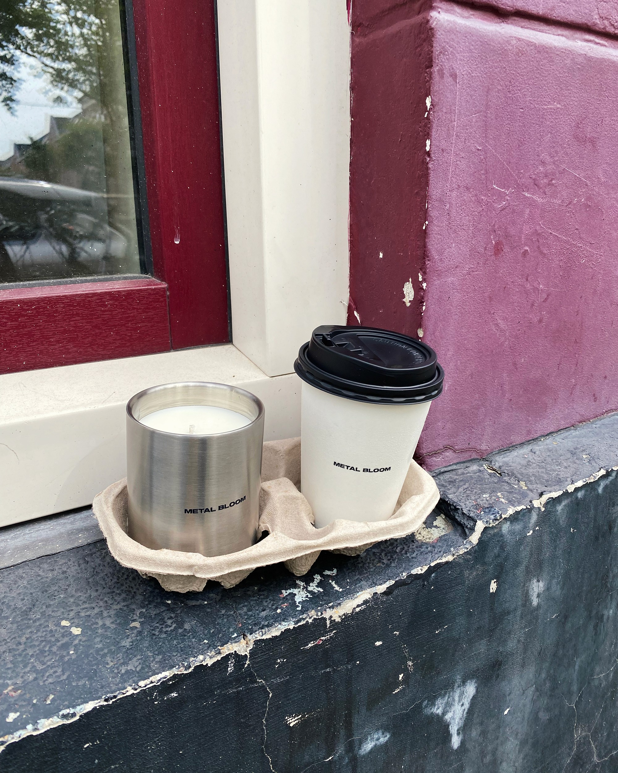 Hand holding a small, handcrafted ceramic cup.