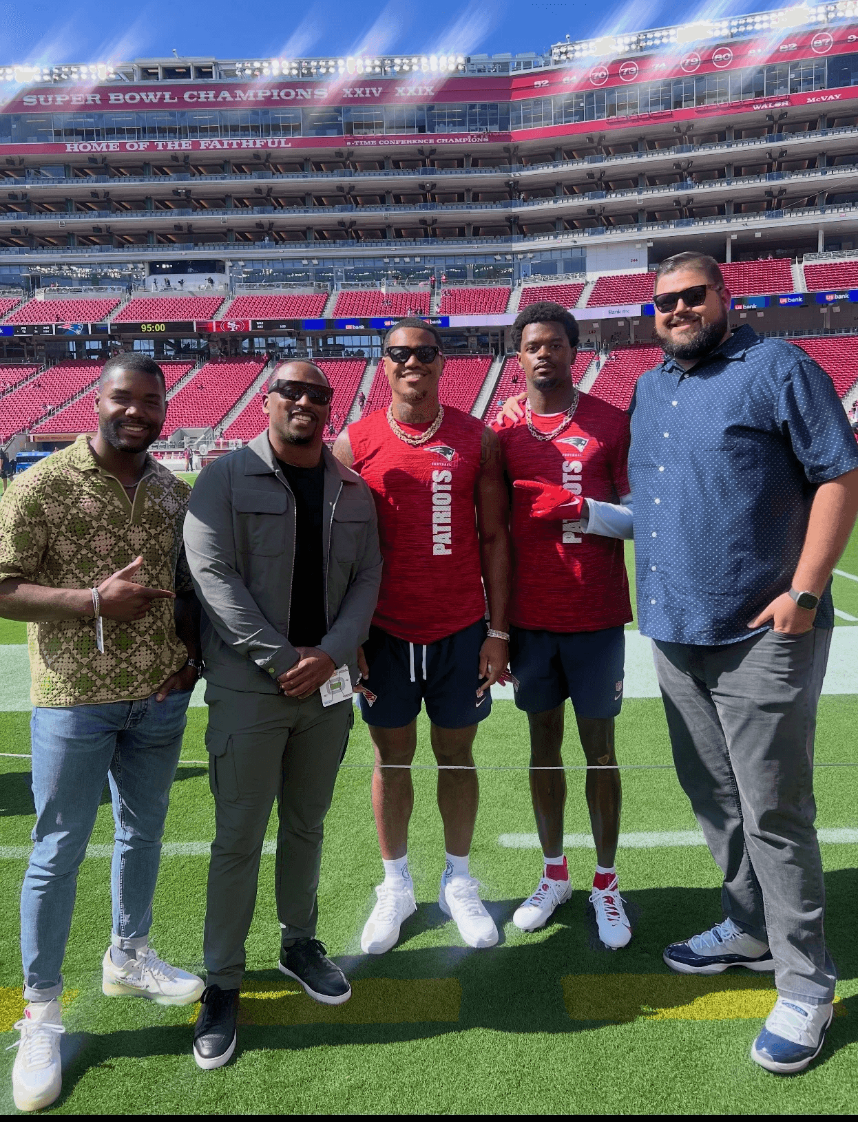 Henry Organ and Al Beglinger with two New England Patriots players on the field